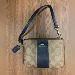 Coach wristlet signature brown logo and navy blue leather like new never used.